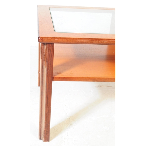614 - British Modern Design - A mid 20th century teak coffee table. The table having central teak top flan... 