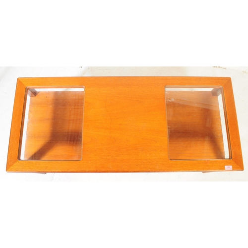 614 - British Modern Design - A mid 20th century teak coffee table. The table having central teak top flan... 