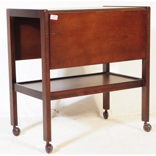 617 - BRITISH MODERN DESIGN - A mid century teak wood butlers hostess serving trolley. Drop leaves to the ... 