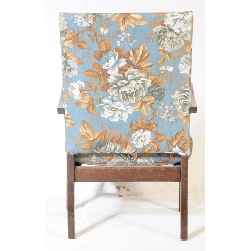620 - A 1940s bentwood Art Deco fireside armchair. Raised on squared legs with chintz upholstered seat and... 