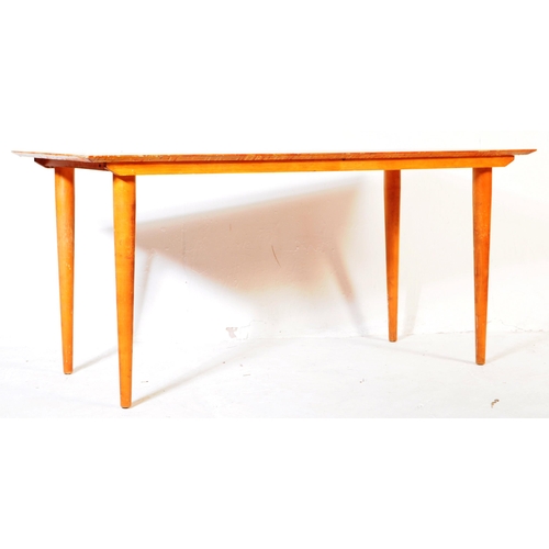 621 - British Modern Design - A Meredew Furniture mid century teak wood dining table. Raised on turned, ta... 