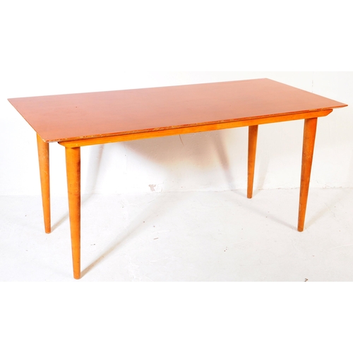 621 - British Modern Design - A Meredew Furniture mid century teak wood dining table. Raised on turned, ta... 