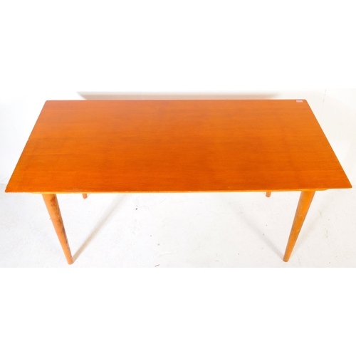 621 - British Modern Design - A Meredew Furniture mid century teak wood dining table. Raised on turned, ta... 