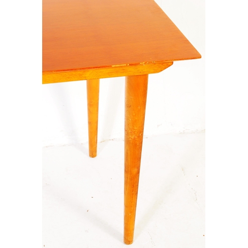 621 - British Modern Design - A Meredew Furniture mid century teak wood dining table. Raised on turned, ta... 