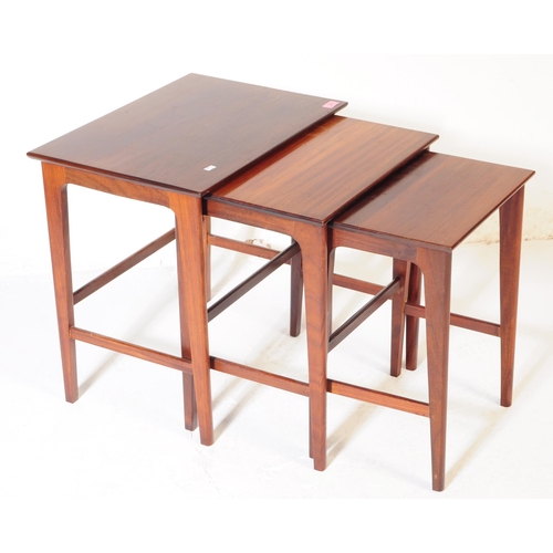 622 - A vintage 20th century teak wood nest of tables. Of rectangular form with upright square supports un... 