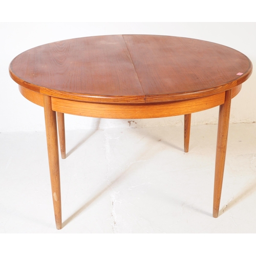 630 - G Plan Furniture - A retro mid 20th century teak dining table with four dining chairs. The table of ... 