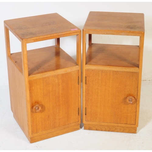 632 - A pair of retro vintage late 20th century plywood bedside cabinets having open upper, above cupboard... 