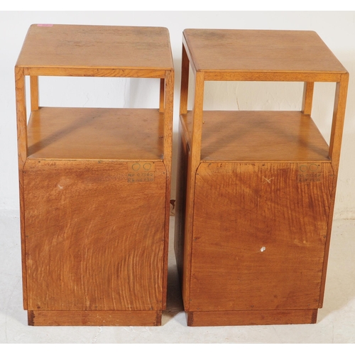 632 - A pair of retro vintage late 20th century plywood bedside cabinets having open upper, above cupboard... 