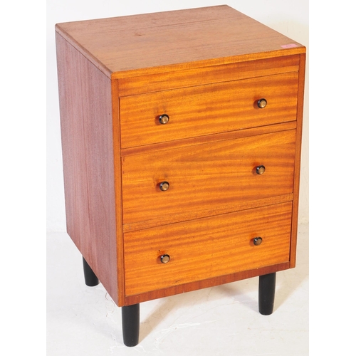 634 - A mid 20th century teak chest of drawers. Of rectangular form with a bank of three drawers. Raised o... 
