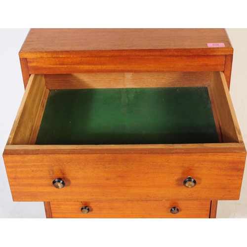 634 - A mid 20th century teak chest of drawers. Of rectangular form with a bank of three drawers. Raised o... 