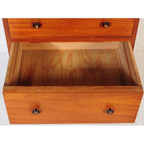 634 - A mid 20th century teak chest of drawers. Of rectangular form with a bank of three drawers. Raised o... 