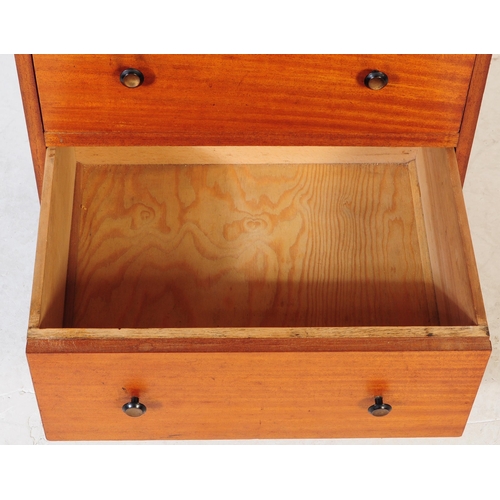 634 - A mid 20th century teak chest of drawers. Of rectangular form with a bank of three drawers. Raised o... 