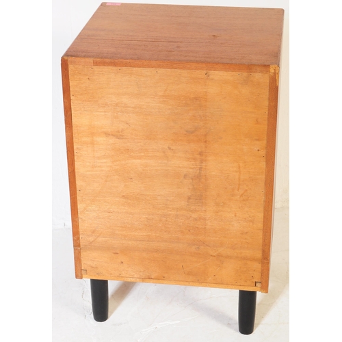 634 - A mid 20th century teak chest of drawers. Of rectangular form with a bank of three drawers. Raised o... 