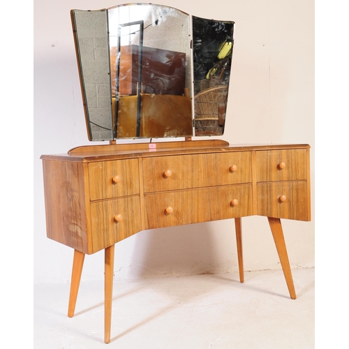 642 - A mid century bleached mahogany dressing table and stool in the manner of Wrighton Furniture. Raised... 