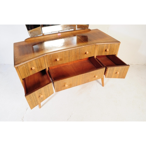 642 - A mid century bleached mahogany dressing table and stool in the manner of Wrighton Furniture. Raised... 