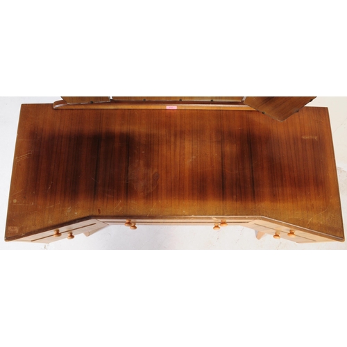 642 - A mid century bleached mahogany dressing table and stool in the manner of Wrighton Furniture. Raised... 