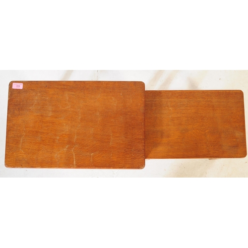 650 - A vintage Robert 'Mouseman' Thompson oak nest of two tables. Having rectangular tops over four octag... 
