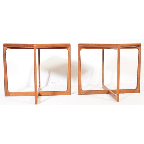 653 - A pair of mid 20th century Danish teak side / occasional tables. Of square form with rectangular sup... 