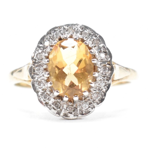 A hallmarked 9ct gold, citrine and diamond halo ring. The ring set with ...