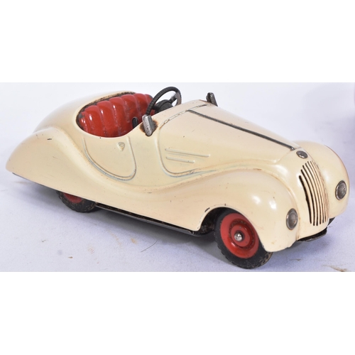 160 - Schuco - a collection of x3 vintage Examico 4001 tinplate clockwork cars, two in cream the other in ... 