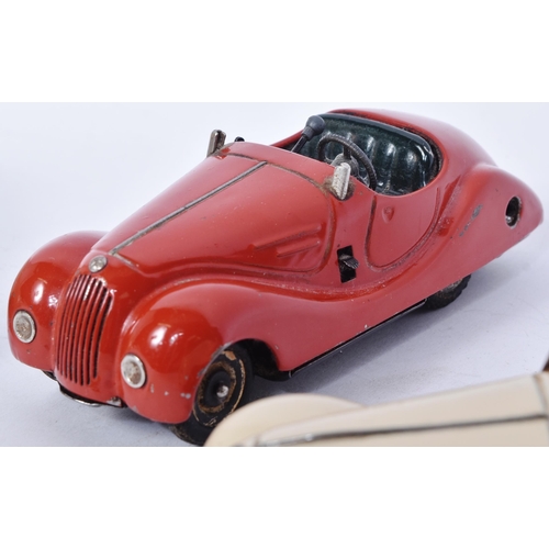 160 - Schuco - a collection of x3 vintage Examico 4001 tinplate clockwork cars, two in cream the other in ... 