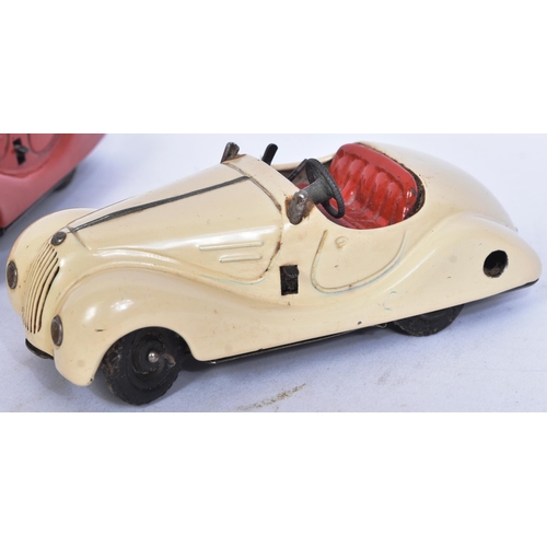 160 - Schuco - a collection of x3 vintage Examico 4001 tinplate clockwork cars, two in cream the other in ... 