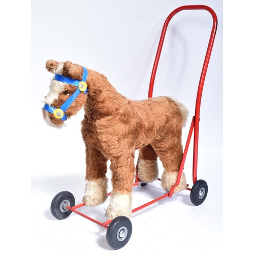 307 - A vintage Triang / Tri-ang childrens rocking horse ' Gee-Gee Rocker ' on a red metal frame with seat... 