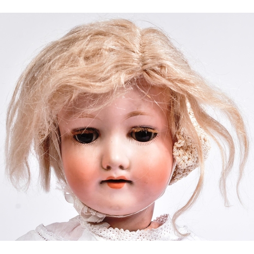 316 - An early 20th Century German Armand Marseille bisque headed doll. Brown flirty eyes, blonde lashes, ... 