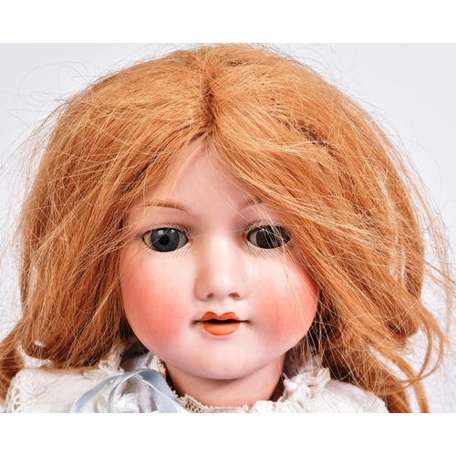 353 - An early 20th Century German Armand Marseille bisque headed doll. The doll with blue flirty eyes, fi... 