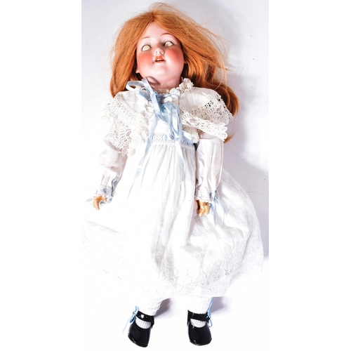 353 - An early 20th Century German Armand Marseille bisque headed doll. The doll with blue flirty eyes, fi... 