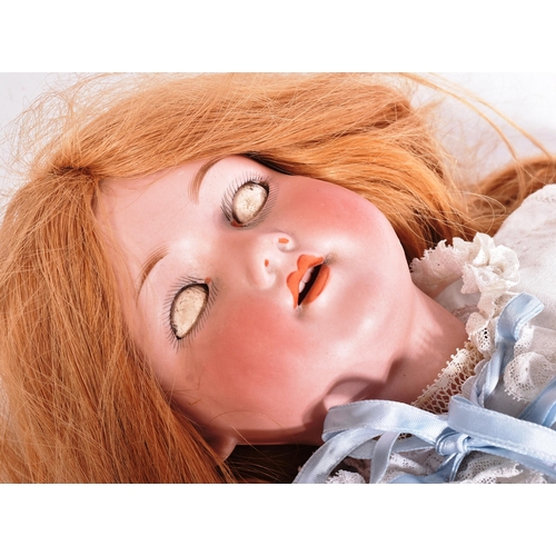 353 - An early 20th Century German Armand Marseille bisque headed doll. The doll with blue flirty eyes, fi... 