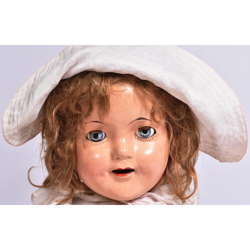 361 - An original vintage Canadian Reliable made Shirley Temple doll. Composition head and body with tin b... 