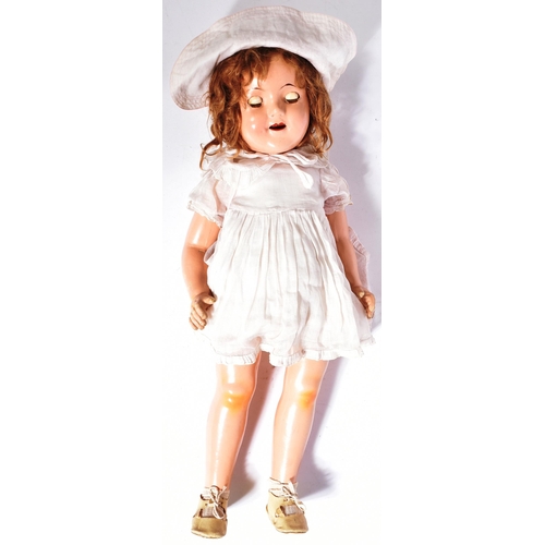 361 - An original vintage Canadian Reliable made Shirley Temple doll. Composition head and body with tin b... 