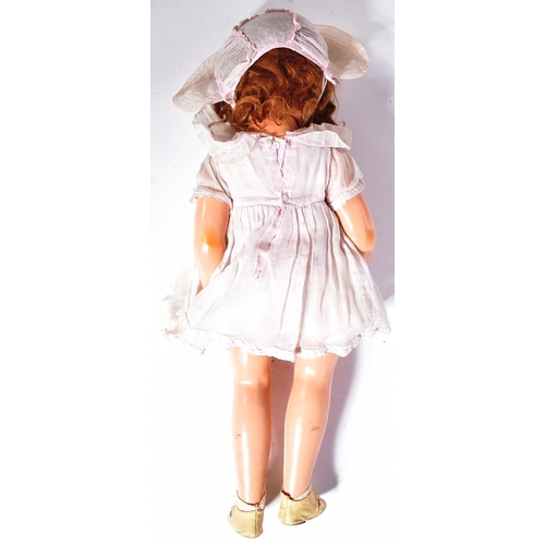 361 - An original vintage Canadian Reliable made Shirley Temple doll. Composition head and body with tin b... 