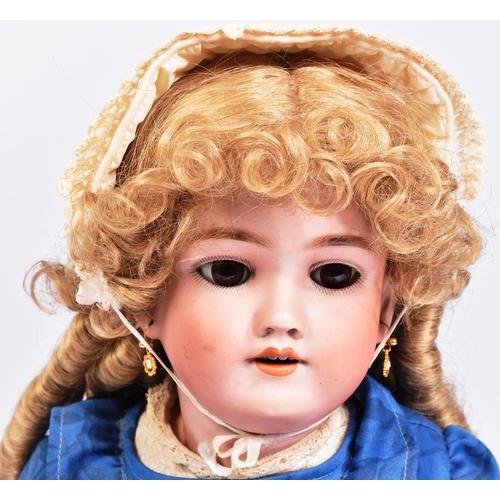 483 - An early 20th Century German Simon & Halbig bisque headed doll. The doll with brown flirty eyes, fin... 