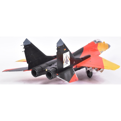 506 - Models - a scale plastic model of a MIG 29A German Luftwaffe Bernd 'Hooters' Pfahler jet, in black, ... 