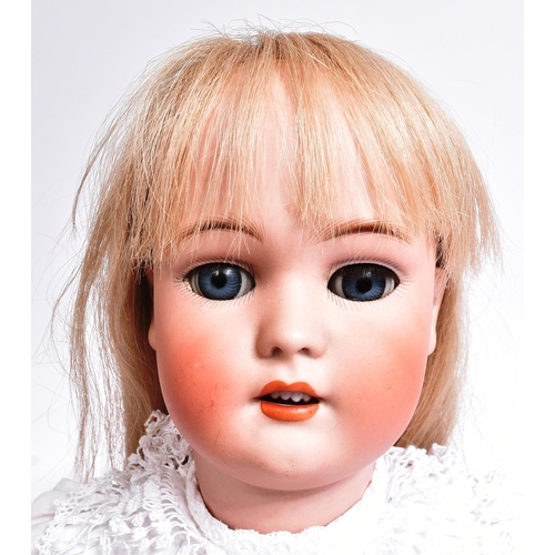 60 - An early 20th Century German Simon & Halbig bisque headed doll. The doll with blue flirty eyes, fine... 