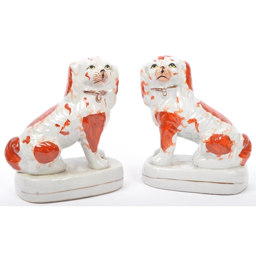 113 - Three early 20th century Staffordshire ceramic spaniel dogs - two being a pair, each painted and mat... 