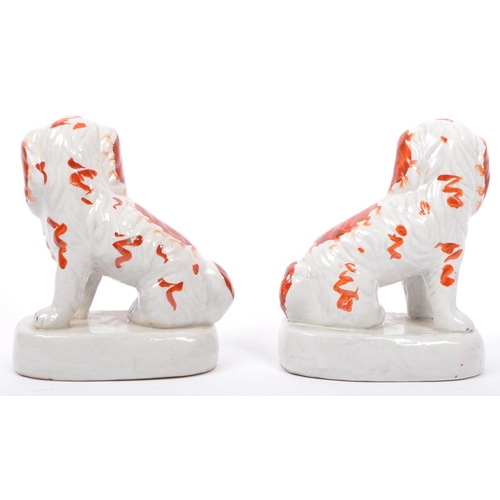 113 - Three early 20th century Staffordshire ceramic spaniel dogs - two being a pair, each painted and mat... 