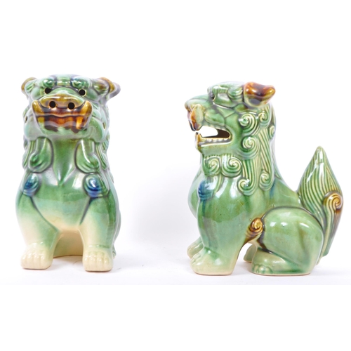 13 - A pair of matching Chinese fu / foo temple dogs being green and yellow / Sancai glazed. Measures 21.... 