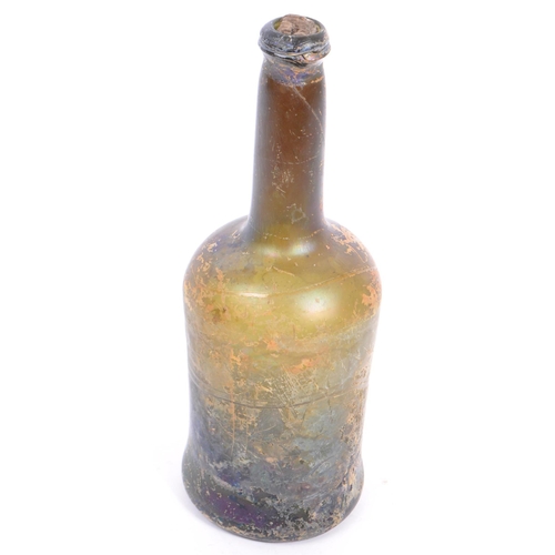 140 - An 18th century circa 1700s glass ship wreck wine bottle with original cork stopper. The glass being... 