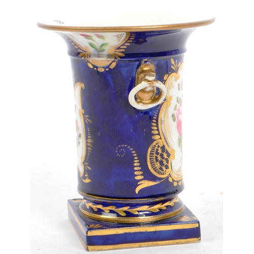 154 - Manner of Coalport porcelain. A Regency 19th century cobalt blue and floral spray decorated spill va... 