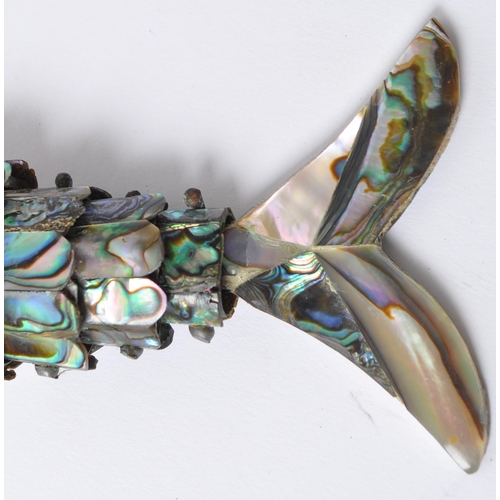 214 - A vintage 20th century abalone articulating fish / bottle opener. Having shell body with metal fixin... 