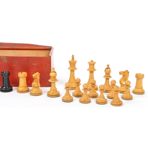 217 - A collection of 20th century turned boxwood and ebony playing chess pieces, each with baize to base.... 