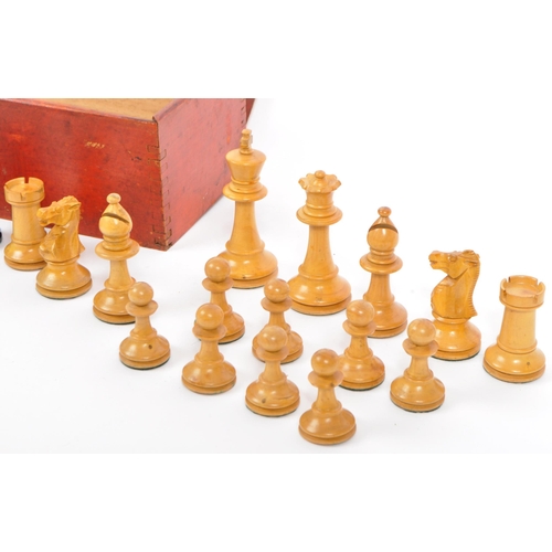 217 - A collection of 20th century turned boxwood and ebony playing chess pieces, each with baize to base.... 