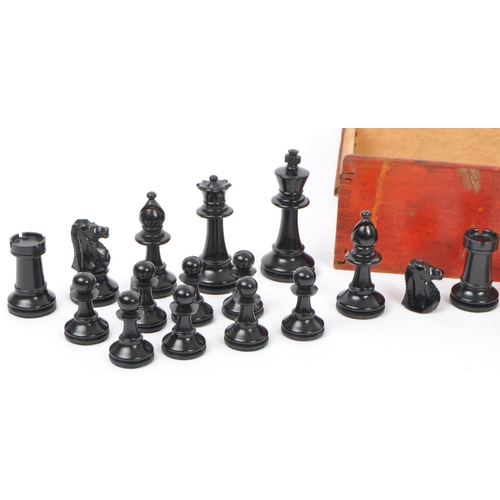 217 - A collection of 20th century turned boxwood and ebony playing chess pieces, each with baize to base.... 