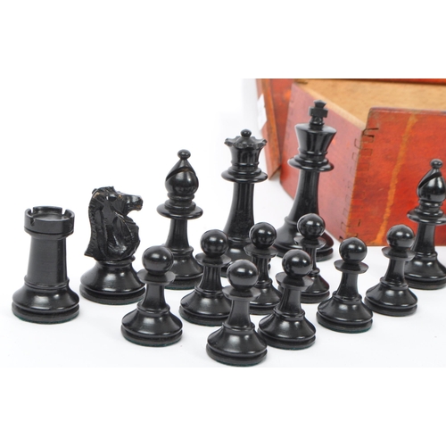 217 - A collection of 20th century turned boxwood and ebony playing chess pieces, each with baize to base.... 