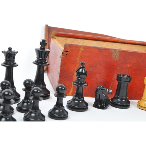 217 - A collection of 20th century turned boxwood and ebony playing chess pieces, each with baize to base.... 