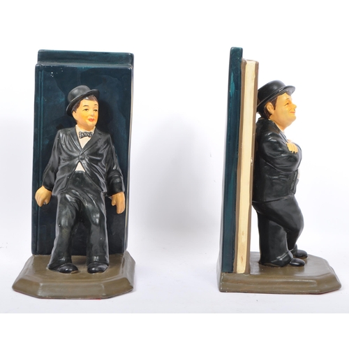 235 - A vintage 1980s pair of ceramic bookends of Stan Laurel and Oliver Hardy. Measures 25.5cm (height).