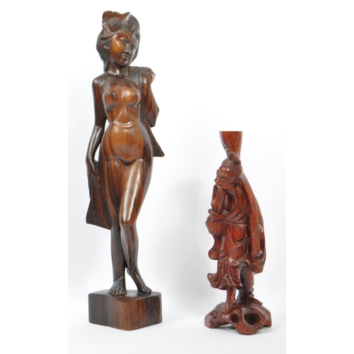 236 - Two vintage 20th century wooden figurines. Consists of a naked Polynesian lady in classic pose, toge... 